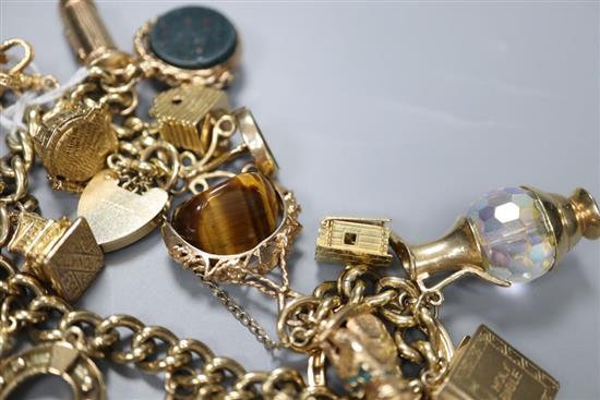 A 9ct gold charm bracelet, hung with twenty two assorted charms including 9ct gold, gross 117.5 grams.